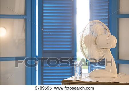 View of a fan at a window with closed shutters. View Large Photo Image Stock Photography - View of a fan at a window with closed shutters.. Fotosearch