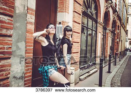 Waiting two young women at the door of a building View Large Photo Image Stock Photo - Waiting two young women at the door of a building. Fotosearch