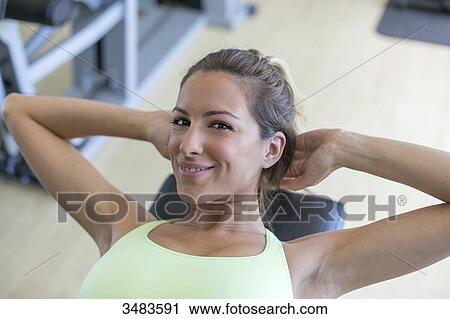 Woman doing crunches in fitness center View Large Photo Image Stock Image - Woman doing crunches in fitness center. Fotosearch