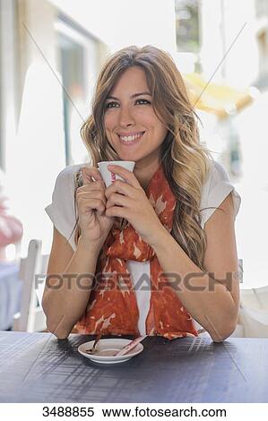 Woman enjoying a coffee in a Cafe View Large Photo Image Stock Photography - Woman enjoying a coffee in a Cafe. Fotosearch