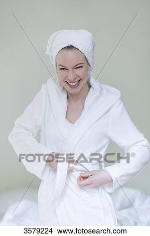 Woman in bathrobe smiling at camera View Large Photo Image Picture - Woman in bathrobe smiling at camera. Fotosearch