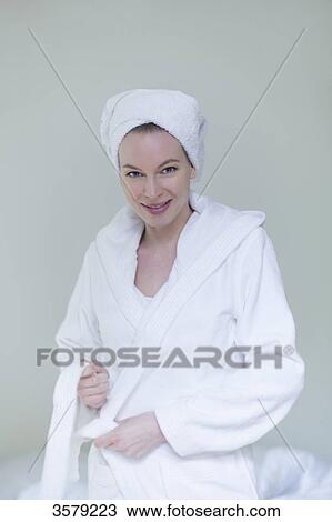 Woman in bathrobe smiling at camera View Large Photo Image Stock Image - Woman in bathrobe smiling at camera. Fotosearch