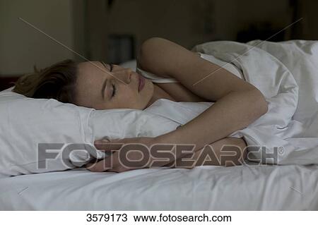 Woman sleeping in bed View Large Photo Image Stock Image - Woman sleeping in bed. Fotosearch