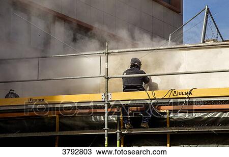 Worker on a building facade restoration View Large Photo Image Stock Image - Worker on a building facade restoration. Fotosearch