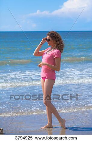 Stock Photography - Youg women at the beach looking on the horizon with sun glasses, Pas de Calais, bitch. Fotosearch