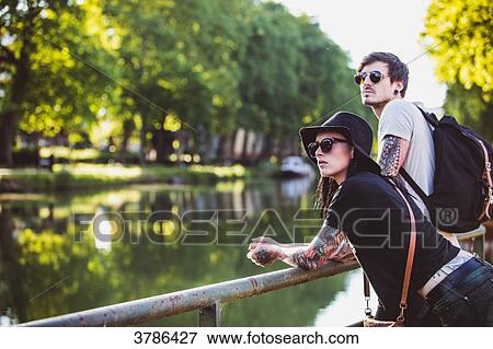 Young couple Garonne edge contemplates the banks View Large Photo Image Stock Photo - Young couple Garonne edge contemplates the banks. Fotosearch
