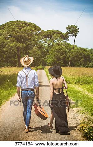 Young couple Hipster ride in the countryside, a guitar in hand View Large Photo Image Picture - Young couple Hipster ride in the countryside, a guitar in hand. Fotosearch