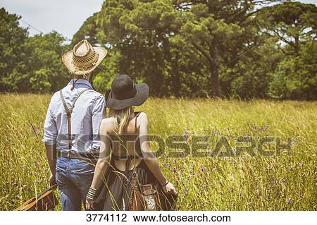 Young couple Hipster ride in the country, holding in one hand a guitar the other View Large Photo Image Stock Image - Young couple Hipster ride in the country, holding in one hand a guitar the other. Fotosearch
