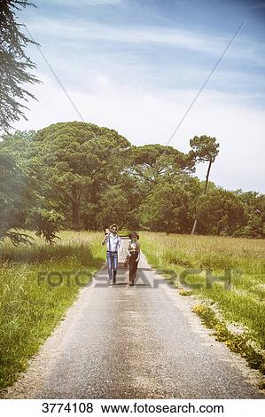 Young couple Hipster ride in the countryside, a guitar on shoulder View Large Photo Image Stock Photo - Young couple Hipster ride in the countryside, a guitar on shoulder. Fotosearch