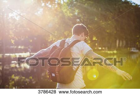 Young Hipster walking along the Garonne arms outstretched View Large Photo Image Stock Photo - Young Hipster walking along the Garonne arms outstretched. Fotosearch