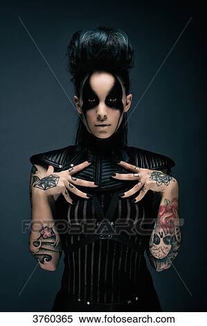 Young woman cyberpunk, tattooed hands on the upper chest, looking at the camera View Large Photo Image Stock Photography - Young woman cyberpunk, tattooed hands on the upper chest, looking at the camera. Fotosearch