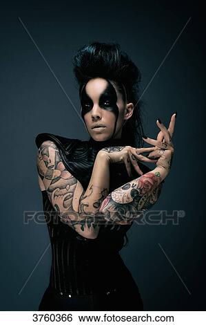 Young woman cyberpunk, tattooed, looking at the camera View Large Photo Image Stock Photograph - Young woman cyberpunk, tattooed, looking at the camera. Fotosearch