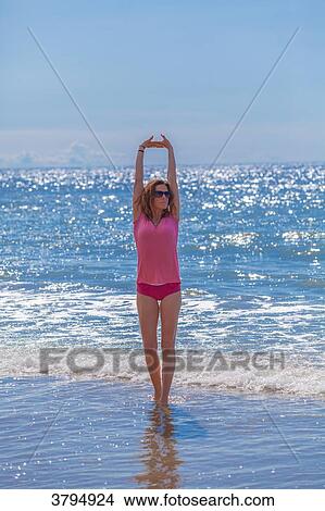Young woman doing stretching exercise on the beach, Pas de Calais, Bitch. View Large Photo Image Picture - Young woman doing stretching exercise on the beach, Pas de Calais, Bitch.. Fotosearch