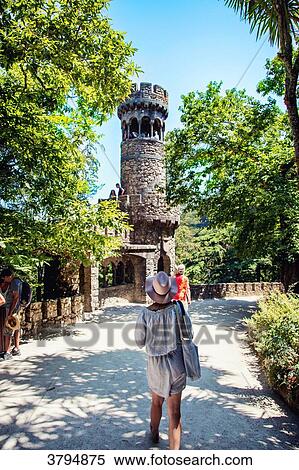 Stock Photography - Young woman from behind walking in the garden of Pena, Sintra, Lisbon area, Portugal. Fotosearch