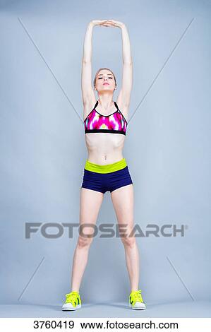 Young woman Length, practical fitness exercises, arms in the air View Large Photo Image Stock Photo - Young woman Length, practical fitness exercises, arms in the air. Fotosearch