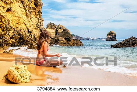 Young woman meditating in the cove of Praia de Galapinhos, Setubal, Lisbon area, Portugal View Large Photo Image Picture - Young woman meditating in the cove of Praia de Galapinhos, Setubal, Lisbon area, Portugal. Fotosearch