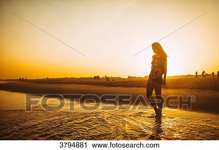 Young woman walking on the beach Praia do Barril in a sunset, deTavira city, region of Algarve, Portugal View Large Photo Image Stock Image - Young woman walking on the beach Praia do Barril in a sunset, deTavira city, region of Algarve, Portugal. Fotosearch