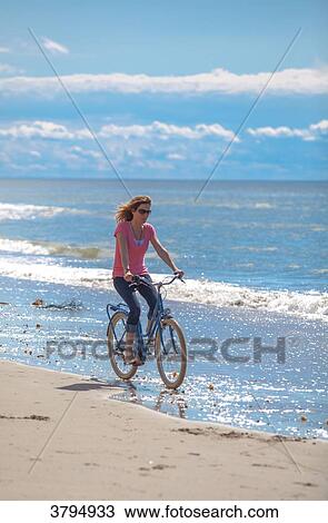 Young women riding a bike on the beach, Pas de Calais, Bitch. View Large Photo Image Stock Image - Young women riding a bike on the beach, Pas de Calais, Bitch.. Fotosearch