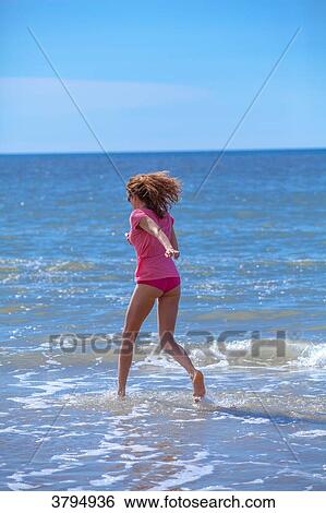 Young women running in the water, Pas de Calais, Bitch. View Large Photo Image Stock Photograph - Young women running in the water, Pas de Calais, Bitch.. Fotosearch