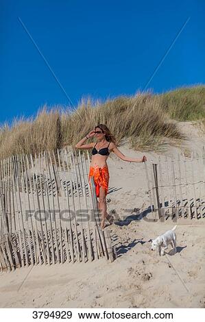 Young women wearing pareo lookin away from the dune, Pas de Calais, Bitch. View Large Photo Image Stock Photo - Young women wearing pareo lookin away from the dune, Pas de Calais, Bitch.. Fotosearch