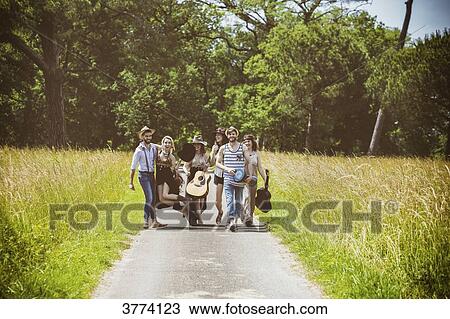Youth group Hipster face, walking on the country road View Large Photo Image Stock Image - Youth group Hipster face, walking on the country road. Fotosearch