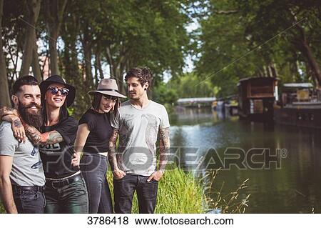 Youth group Hipster on the banks of the Garonne, barges in the background View Large Photo Image Stock Photo - Youth group Hipster on the banks of the Garonne, barges in the background. Fotosearch