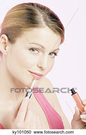 Young Woman face making-up with a lipstick, close-up (studio) View Large Photo Image Stock Image - Young Woman face making-up with a lipstick, close-up (studio). Fotosearch