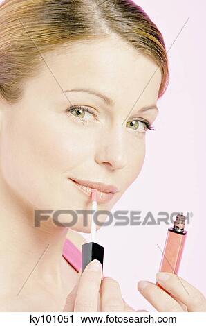 Young Woman face making-up with a lipstick, close-up (studio) View Large Photo Image Stock Image - Young Woman face making-up with a lipstick, close-up (studio). Fotosearch