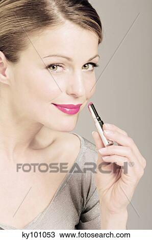 Young Woman face making-up with a lipstick, close-up (studio) View Large Photo Image Stock Image - Young Woman face making-up with a lipstick, close-up (studio). Fotosearch