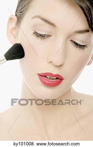 Young Woman face making-up with a brush, close-up (studio) View Large Photo Image Stock Photo - Young Woman face making-up with a brush, close-up (studio). Fotosearch