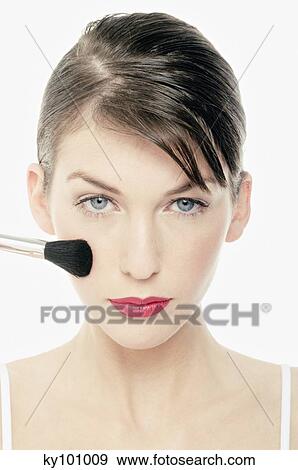 Young Woman face making-up with a brush, close-up (studio) View Large Photo Image Stock Photo - Young Woman face making-up with a brush, close-up (studio). Fotosearch