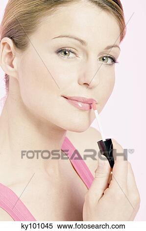 Young Woman face making-up with a lipstick, close-up (studio) View Large Photo Image Stock Photography - Young Woman face making-up with a lipstick, close-up (studio). Fotosearch