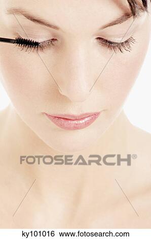 Young Woman face making-up with mascara, close-up (studio) View Large Photo Image Stock Photograph - Young Woman face making-up with mascara, close-up (studio). Fotosearch