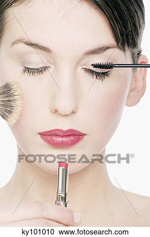 Young Woman face with Make-Up, a pencil, lipstick and a brush in front of her, close-up (studio) View Large Photo Image Stock Image - Young Woman face with Make-Up, a pencil, lipstick and a brush in front of her, close-up (studio). Fotosearch