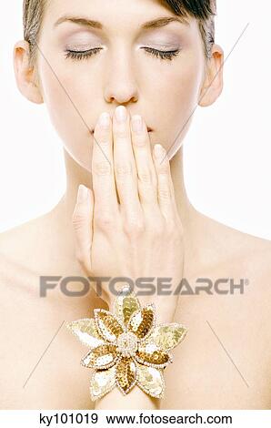 Young Woman face with make up, having her hand in front of her mouth, close-up (studio) View Large Photo Image Stock Photo - Young Woman face with make up, having her hand in front of her mouth, close-up (studio). Fotosearch