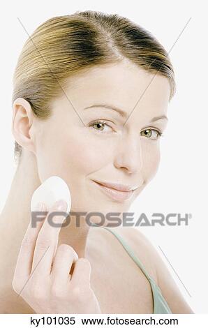 Young Woman face with make up, holding a cleansing cotton (studio) View Large Photo Image Stock Photography - Young Woman face with make up, holding a cleansing cotton (studio). Fotosearch