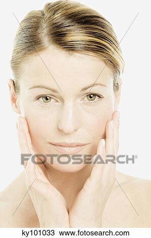 Young Woman face with make up, looking at the camera, putting her hands on her cheeks (studio) View Large Photo Image Stock Image - Young Woman face with make up, looking at the camera, putting her hands on her cheeks (studio). Fotosearch