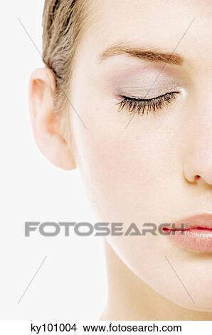 Young Woman half face with make up, eyes shut, close-up (studio) View Large Photo Image Picture - Young Woman half face with make up, eyes shut, close-up (studio). Fotosearch