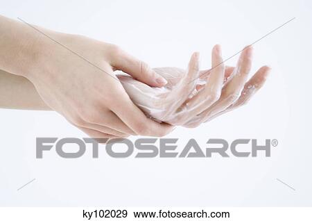 Woman applying moisturizer to hand, close up (studio) View Large Photo Image Stock Photo - Woman applying moisturizer to hand, close up (studio). Fotosearch