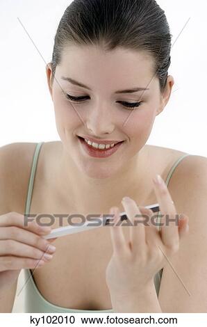 Woman filing her nails (studio) View Large Photo Image Stock Image - Woman filing her nails (studio). Fotosearch