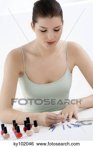 Woman manicure with different accessories in front of her (studio) View Large Photo Image Stock Photograph - Woman manicure with different accessories in front of her (studio). Fotosearch