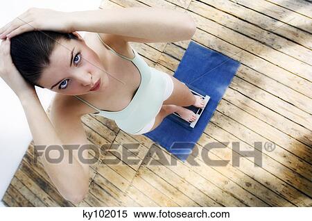 Stock Photography - Woman on scales. Fotosearch
