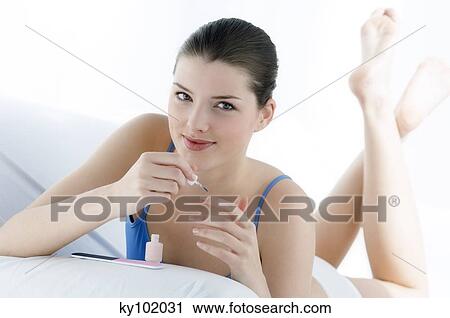 Woman painting her fingernails, inside View Large Photo Image Stock Image - Woman painting her fingernails, inside. Fotosearch