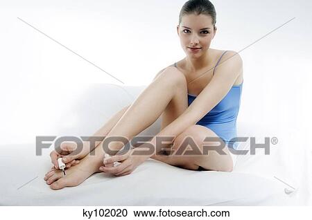 Woman painting her toenails View Large Photo Image Stock Image - Woman painting her toenails. Fotosearch