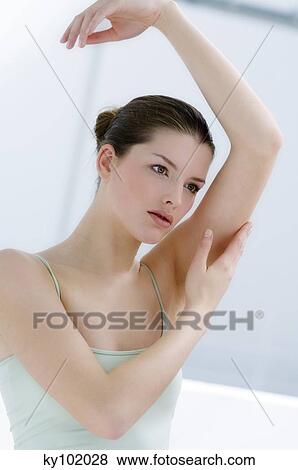 Woman touching her arm, inside View Large Photo Image Stock Photo - Woman touching her arm, inside. Fotosearch