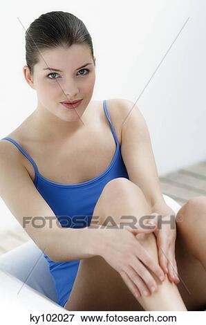 Woman touching her legs, inside View Large Photo Image Stock Photo - Woman touching her legs, inside. Fotosearch