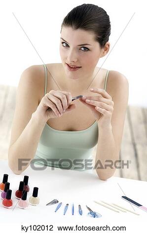 Woman trimming fingernails, inside View Large Photo Image Stock Image - Woman trimming fingernails, inside. Fotosearch