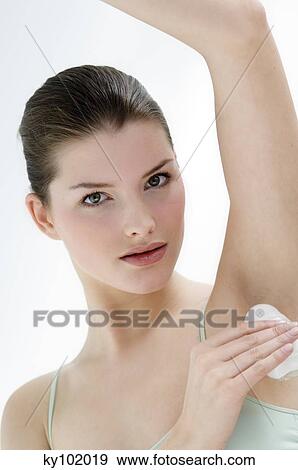 Woman using deodorant View Large Photo Image Stock Photo - Woman using deodorant. Fotosearch
