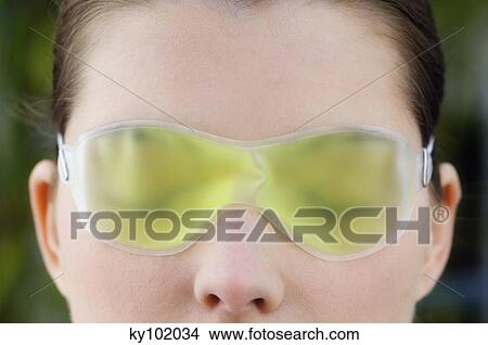 Woman with a gel eye mask, close up (studio) View Large Photo Image Picture - Woman with a gel eye mask, close up (studio). Fotosearch