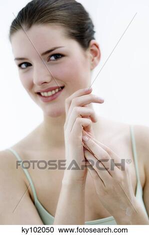 Young woman face looking at the camera, smiling, inside View Large Photo Image Stock Image - Young woman face looking at the camera, smiling, inside. Fotosearch